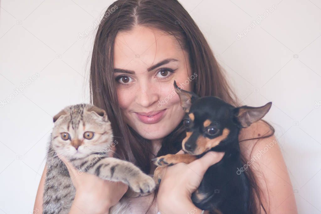 pets and owners. girl, cat and her dog on a white background