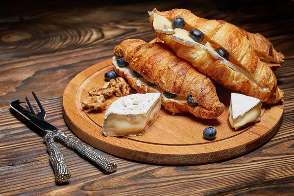 Croissants Cheese Nuts Blueberries Wooden Board Knife Fork Cheese Concept — Stock Photo, Image