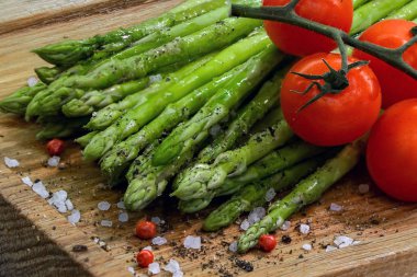 ahşap boarg üzerinde taze sebze kuşkonus ve domates