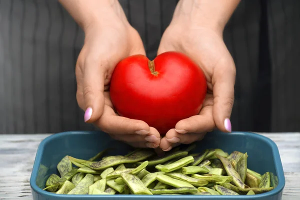 Tomato in the shape of a heart in female hands. Healthy food. — Stock Photo, Image