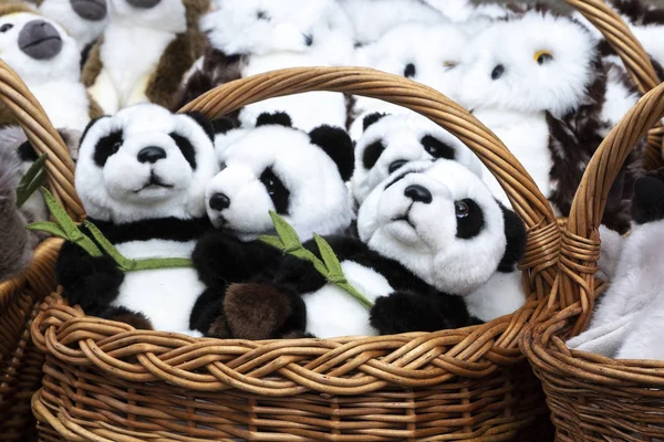 Muchos juguetes blandos de panda en una cesta de mimbre. de cerca Imagen de stock