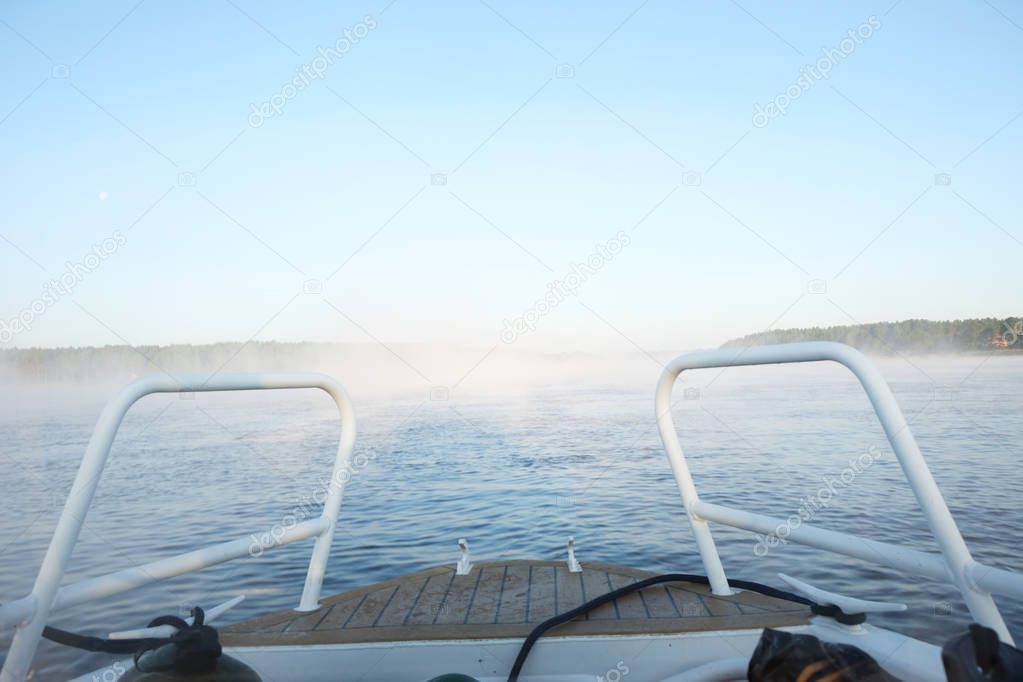 foggy lake Ladoga in the morning from the bow of a motor boat. landscape.
