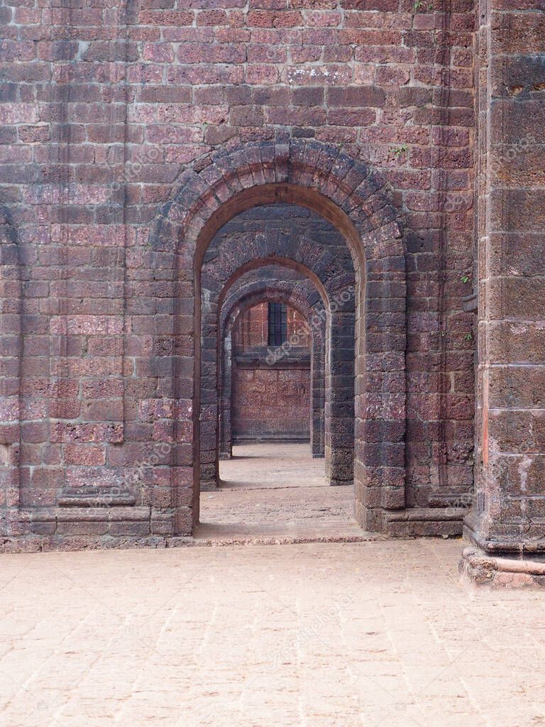 View of the old stone arches of the chapel going into the distance. Architecture of old buildings