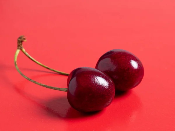 Baya Cereza Madura Jugosa Brillante Aislada Sobre Fondo Rojo — Foto de Stock