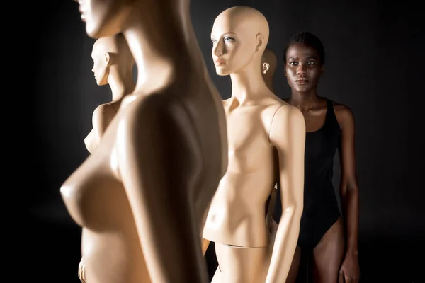 Young African American Woman Swimsuit Looking Camera While Standing Mannequins — Stock Photo, Image
