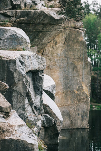 close-up shot of dramatic rocky cliff over lake