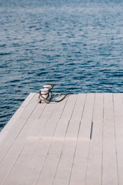 empty wooden pier and blue water at summer day clipart