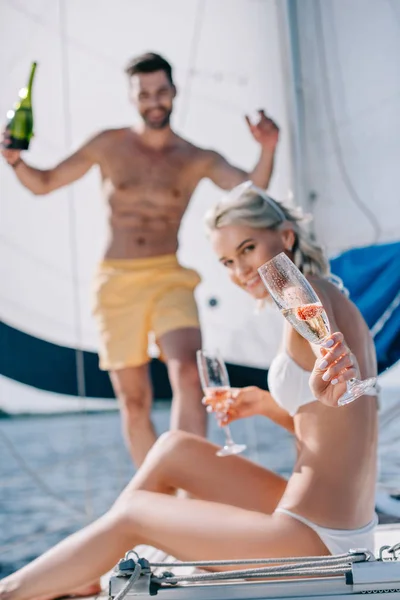 Selective Focus Smiling Woman Showing Glass Champagne Her Boyfriend Standing — Stock Photo, Image