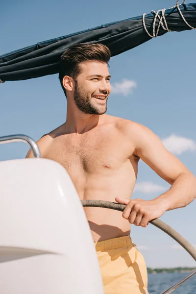 Smiling Shirtless Muscular Man Swim Trunks Steering Yacht — Stock Photo, Image