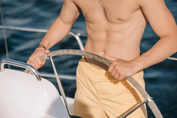 Cropped Image Shirtless Muscular Man Swim Trunks Steering Yacht — Stock Photo, Image