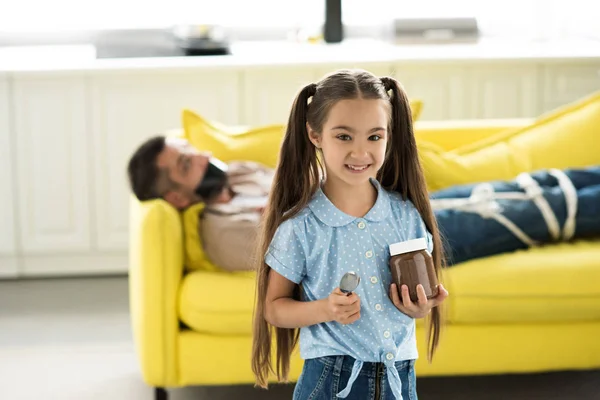 Father Lying Tied Sofa Smiling Daughter Holding Chocolate Home — Stock Photo, Image