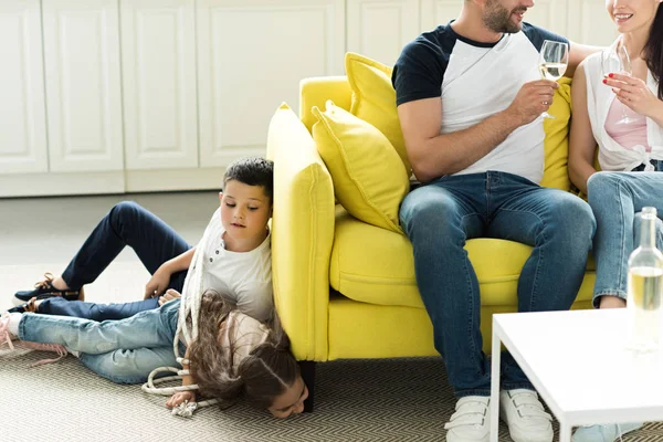 Parents Drinking Wine Tied Children Lying Floor Home Parenthood Concept — Free Stock Photo