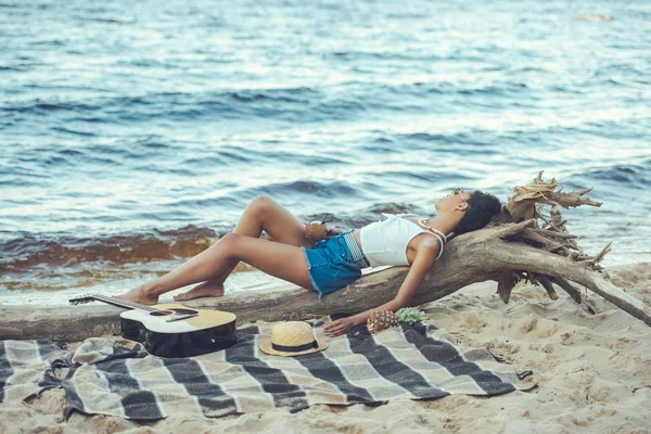 木製ログオン ビーチで休んでカクテルを飲むと若いアフリカ系アメリカ人女性 — ストック写真