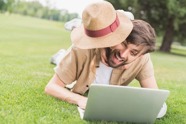 Feliz Padre Hija Abrazando Mientras Usa Ordenador Portátil Césped Parque — Foto de Stock