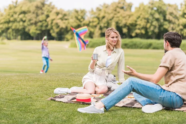 Parents Sitting Plaid Picnic While Daughter Lying Park — Stock Photo, Image