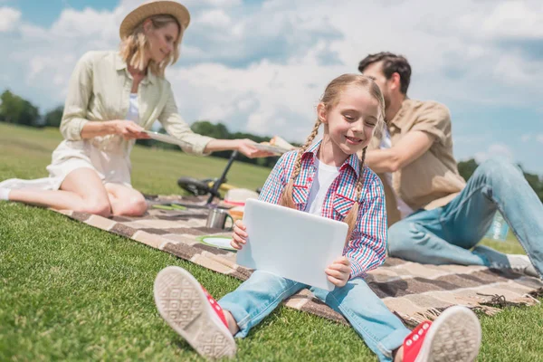 Bedårende Smilende Barn Bruker Digital Nettbrett Mens Foreldre Sitter Bakerst – stockfoto