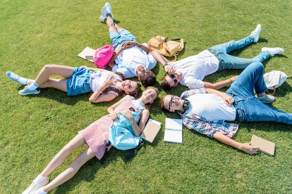 High Angle View Smiling Teenage Classmates Books Backpacks Lying Together — Stock Photo, Image