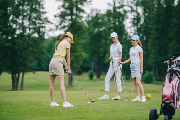 Mujer Gorra Jugando Golf Mientras Sonríe Amigos Pie Cerca Campo —  Fotos de Stock