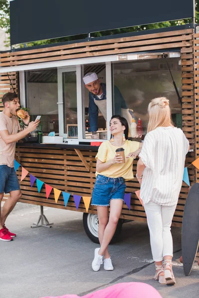 Man Eating Burger Girls Drinking Coffee Food Truck — Stock Photo, Image