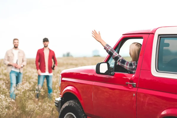 Young Woman Driving Car Car Field Waving Men Standing Her — Stock Photo, Image