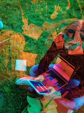 double exposure photo on student using tablet while sitting on green grass in park clipart