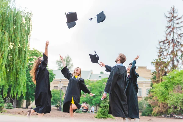 Happy Multicultural Graduates Diplomas Throwing Caps Park — Stock Photo, Image