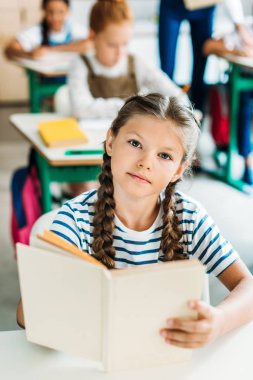 okul ders sırasında kameraya bakarak kitap ile güzel liseli kızlar
