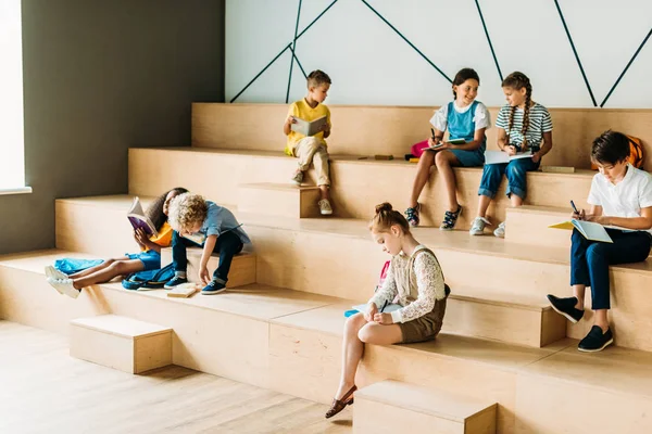 Skupina Žáků Notebooky Studovat Dřevěných Tribun Školní Chodbě — Stock fotografie