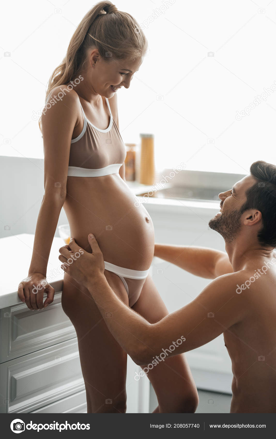 Side View Man Hugging Pregnant Wife Underwear Kitchen Home Stock Photo by ©ArturVerkhovetskiy 208057740 pic