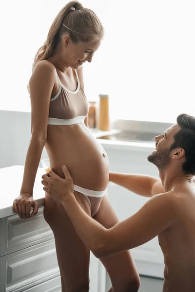 Side View Man Hugging Pregnant Wife Underwear Kitchen Home — Stock Photo, Image