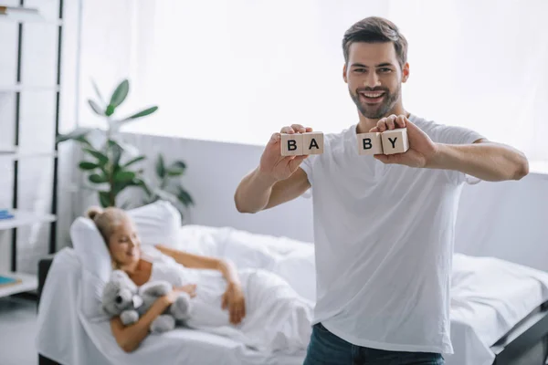Selective Focus Smiling Man Showing Wooden Blocks Baby Inscription While — Stock Photo, Image