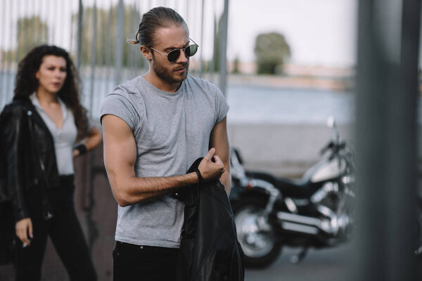 young couple of bikers with classical motorcycle for trip
