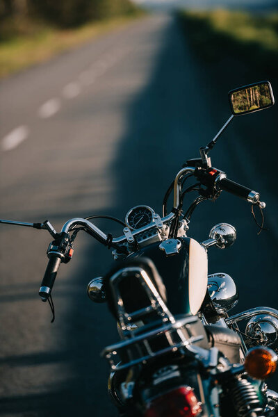cruiser motorcycle standing on asphalt road