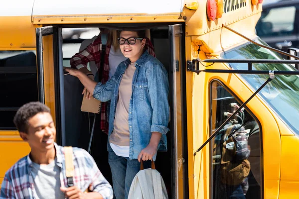 Happy Teen Schoolboy Walking Out School Bus Classmates — Free Stock Photo