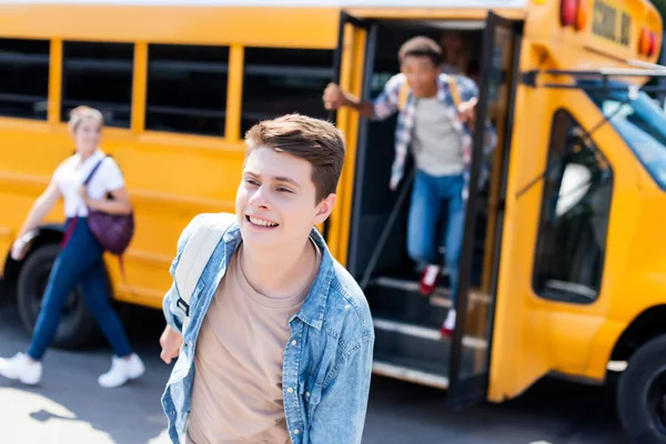 Happy Teen Schoolboy Running Out School Bus Blurred Classmates Background — Stock Photo, Image