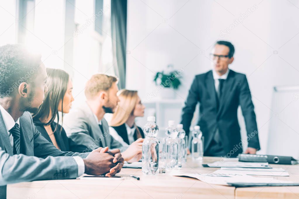 multiethnic businesspeople having conversation in conference hall