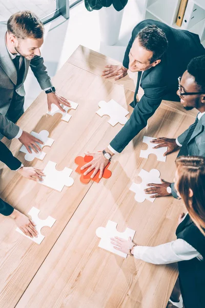 High Angle View Multiracial Businesspeople Assembling Puzzle Conference Table — Stock Photo, Image