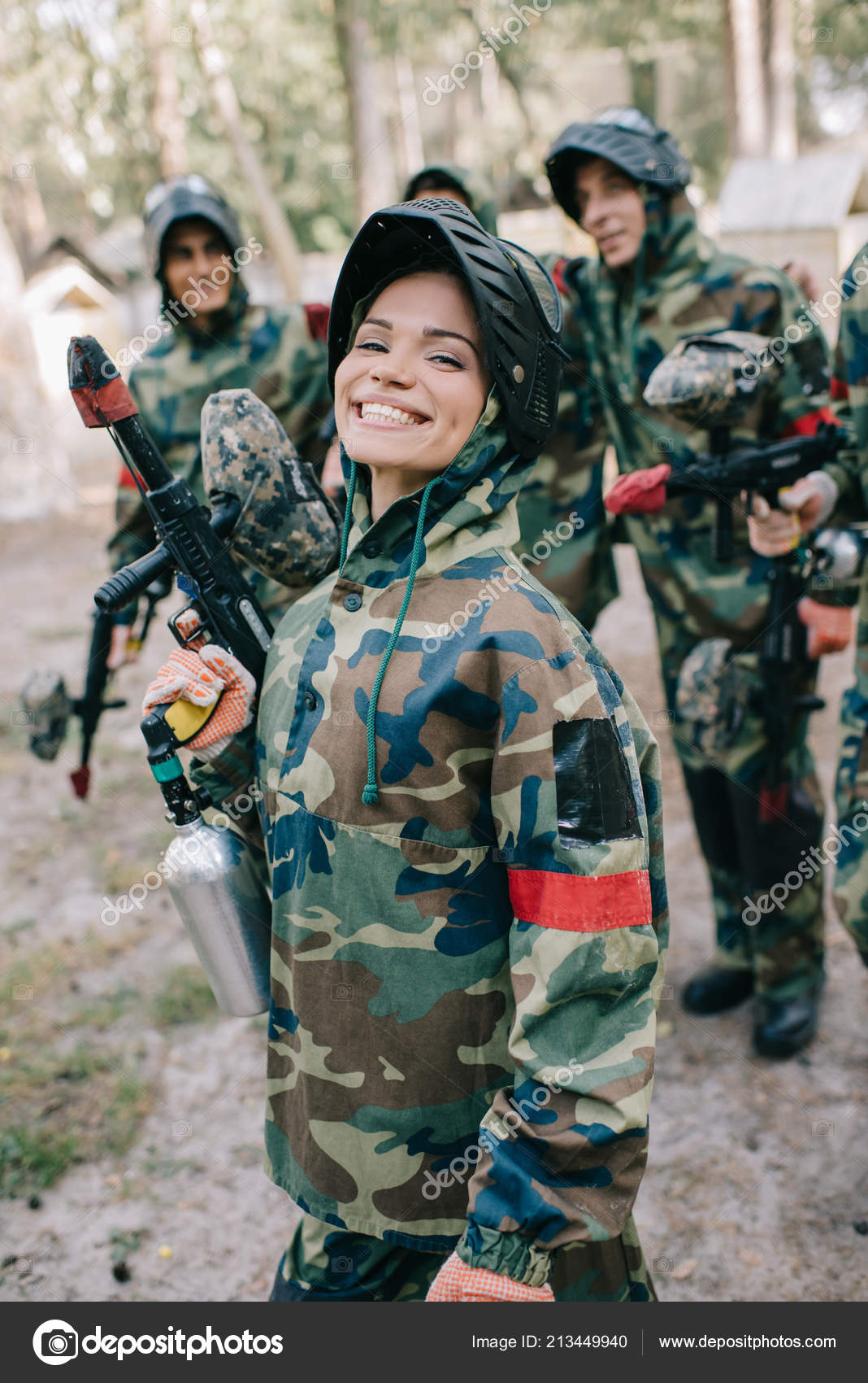Attractive Smiling Female Paintballer Uniform Holding Paintball Gun