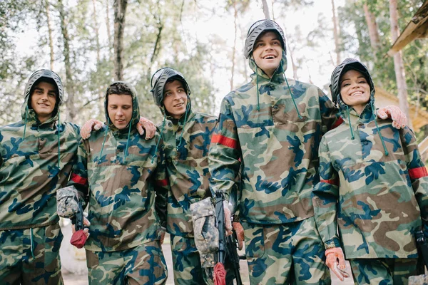 Felices Jugadores Paintball Camuflaje Con Pistolas Marcadoras Abrazándose Aire Libre —  Fotos de Stock