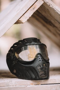 selective focus of protective mask covered by paintball splash outdoors  clipart