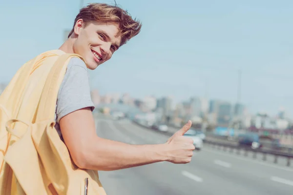 Smiling Young Man Hitchhiking Road — Stock Photo, Image