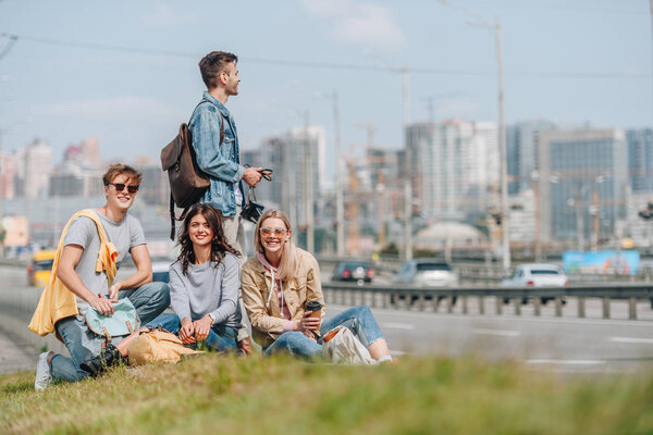 group of young travelers with backpacks in new city