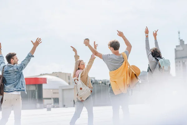 Vue Arrière Des Voyageurs Élégants Dansant Gestualisant Marchant Dans Ville — Photo gratuite