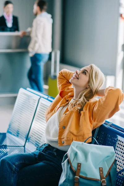 Attractive Happy Girl Hands Head Sitting Looking Airport Terminal — Stock Photo, Image