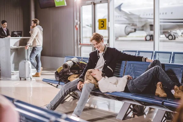 Young Couple Smiling Each Other While Waiting Flight Airport — Free Stock Photo
