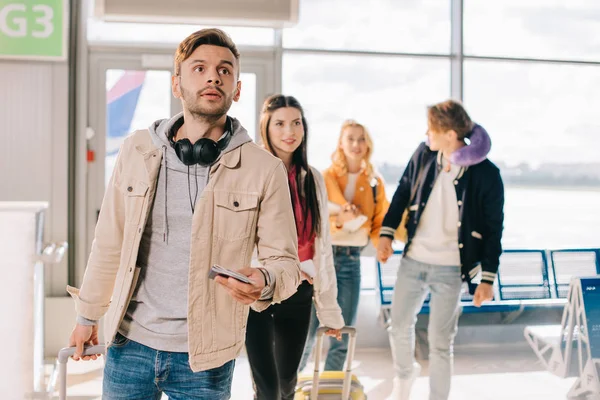 Young Man Holding Passport Looking While Traveling Friends Airport — Stock Photo, Image