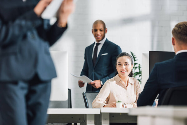 young multiracial business colleagues working together in open space office