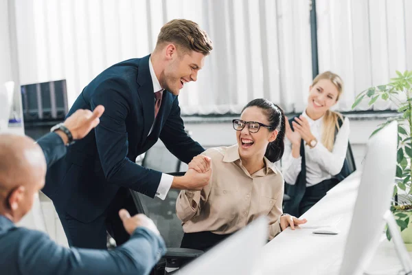 Cheerful Young Business People Greeting Happy Colleague Office — Stock Photo, Image