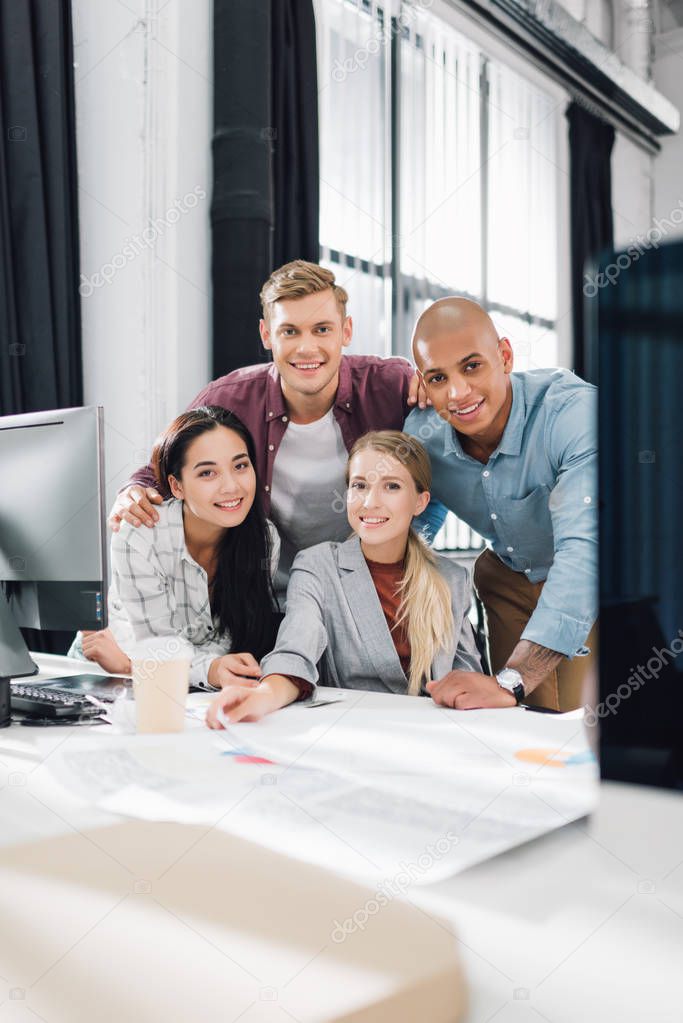 happy young multiracial business colleagues smiling at camera in office  