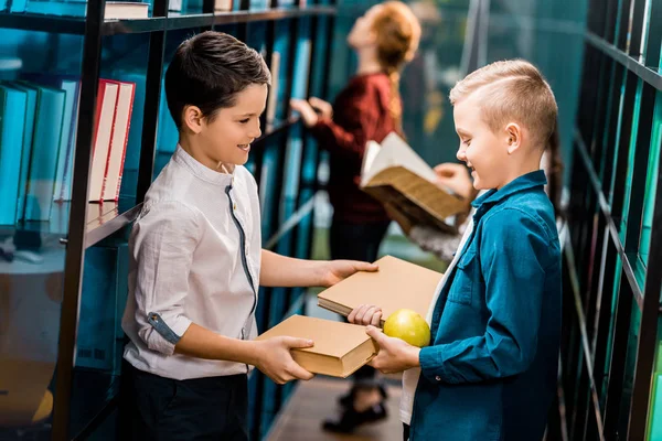 Side View Cute Smiling Schoolkids Holding Books Apple Library — Stock Photo, Image